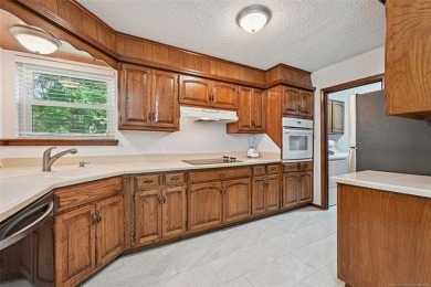 This spacious home sits on a fully fenced 0.61-acre lot and on Forest Ridge Golf Club in Oklahoma - for sale on GolfHomes.com, golf home, golf lot