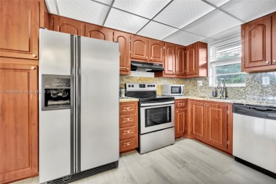 Remodeled apartment with stunning golf course and lake views! on Grande Oaks Golf Club in Florida - for sale on GolfHomes.com, golf home, golf lot