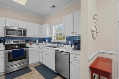Welcome to this charming 2 bedroom, 2 bathroom top-floor condo on Barefoot Resort and Golf Club  in South Carolina - for sale on GolfHomes.com, golf home, golf lot