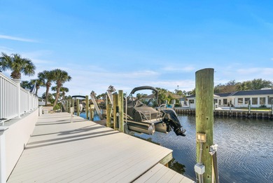 Tucked behind the private gates of the Bay Point community, this on Bay Point Resort Golf Club in Florida - for sale on GolfHomes.com, golf home, golf lot