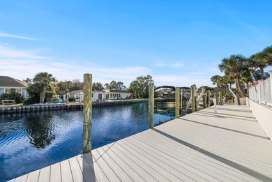 Tucked behind the private gates of the Bay Point community, this on Bay Point Resort Golf Club in Florida - for sale on GolfHomes.com, golf home, golf lot