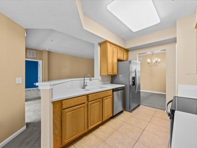 Enjoy Florida living in this delightful first-floor, end unit on ChampionsGate Golf Resort in Florida - for sale on GolfHomes.com, golf home, golf lot