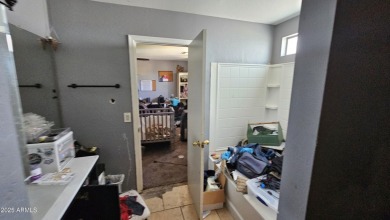 Investor special! Spacious 5-bedroom, 2.5-bath fixer-upper on Oasis Golf Club in Arizona - for sale on GolfHomes.com, golf home, golf lot