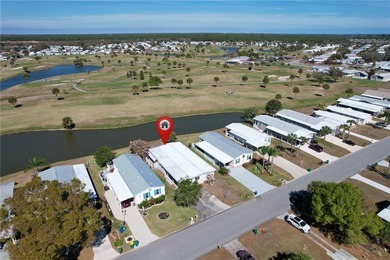 One of the best views in Barefoot Bay, overlooking both the golf on Barefoot Bay Golf Course in Florida - for sale on GolfHomes.com, golf home, golf lot