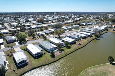 One of the best views in Barefoot Bay, overlooking both the golf on Barefoot Bay Golf Course in Florida - for sale on GolfHomes.com, golf home, golf lot