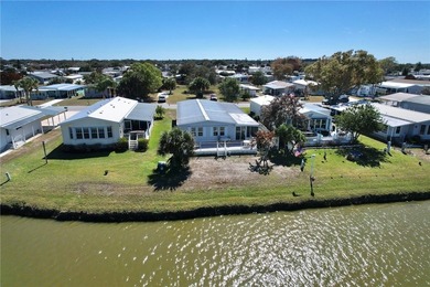 One of the best views in Barefoot Bay, overlooking both the golf on Barefoot Bay Golf Course in Florida - for sale on GolfHomes.com, golf home, golf lot