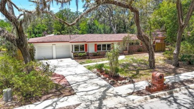 Come see this well-maintained 3-bedroom, 2.5-bath midcentury on Temple Terrace Golf and Country Club in Florida - for sale on GolfHomes.com, golf home, golf lot