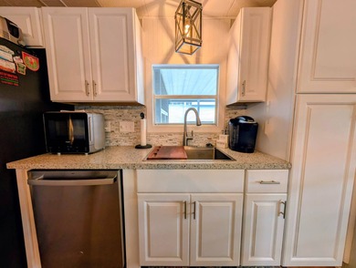 This immaculate home exudes charm and elegance, perfectly on Grasslands Golf and Country Club in Florida - for sale on GolfHomes.com, golf home, golf lot