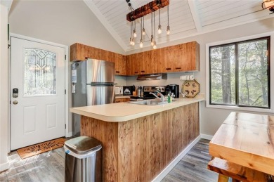 This spectacular villa offers seasonal views of Lake Petit and on Big Canoe Golf Club - Cherokee in Georgia - for sale on GolfHomes.com, golf home, golf lot