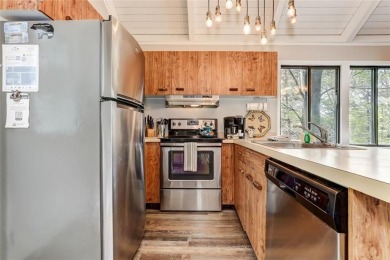 This spectacular villa offers seasonal views of Lake Petit and on Big Canoe Golf Club - Cherokee in Georgia - for sale on GolfHomes.com, golf home, golf lot