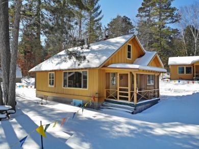 This charming vintage 2 bedroom log sided cottage offers a cozy on  in Wisconsin - for sale on GolfHomes.com, golf home, golf lot