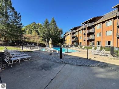 Enjoy a view of the pool from this nicely updated 1 bedroom on Cedar River Golf Course in Michigan - for sale on GolfHomes.com, golf home, golf lot