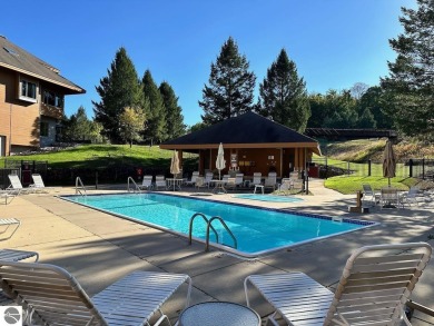 Enjoy a view of the pool from this nicely updated 1 bedroom on Cedar River Golf Course in Michigan - for sale on GolfHomes.com, golf home, golf lot