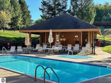 Enjoy a view of the pool from this nicely updated 1 bedroom on Cedar River Golf Course in Michigan - for sale on GolfHomes.com, golf home, golf lot