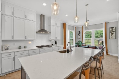 Situated atop a spacious corner lot in Hasentree, this on Hasentree Club in North Carolina - for sale on GolfHomes.com, golf home, golf lot