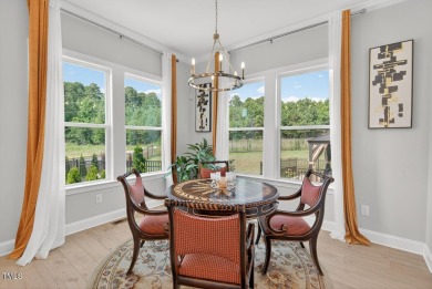 Situated atop a spacious corner lot in Hasentree, this on Hasentree Club in North Carolina - for sale on GolfHomes.com, golf home, golf lot