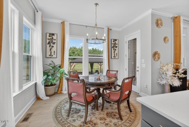 Situated atop a spacious corner lot in Hasentree, this on Hasentree Club in North Carolina - for sale on GolfHomes.com, golf home, golf lot