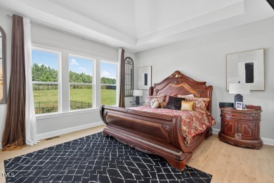 Situated atop a spacious corner lot in Hasentree, this on Hasentree Club in North Carolina - for sale on GolfHomes.com, golf home, golf lot