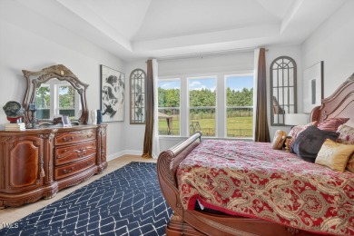 Situated atop a spacious corner lot in Hasentree, this on Hasentree Club in North Carolina - for sale on GolfHomes.com, golf home, golf lot