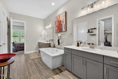 Situated atop a spacious corner lot in Hasentree, this on Hasentree Club in North Carolina - for sale on GolfHomes.com, golf home, golf lot