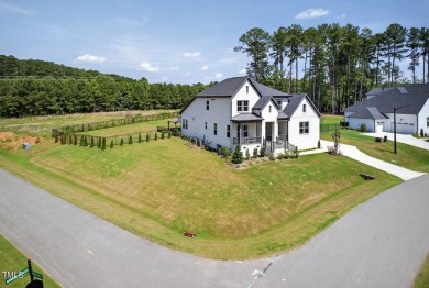 Situated atop a spacious corner lot in Hasentree, this on Hasentree Club in North Carolina - for sale on GolfHomes.com, golf home, golf lot