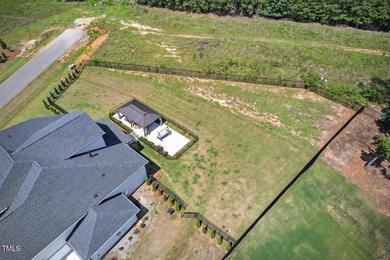 Situated atop a spacious corner lot in Hasentree, this on Hasentree Club in North Carolina - for sale on GolfHomes.com, golf home, golf lot