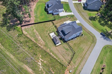 Situated atop a spacious corner lot in Hasentree, this on Hasentree Club in North Carolina - for sale on GolfHomes.com, golf home, golf lot