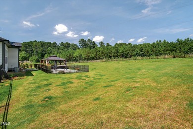 Situated atop a spacious corner lot in Hasentree, this on Hasentree Club in North Carolina - for sale on GolfHomes.com, golf home, golf lot