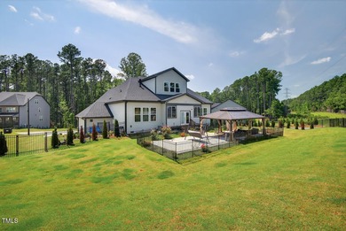 Situated atop a spacious corner lot in Hasentree, this on Hasentree Club in North Carolina - for sale on GolfHomes.com, golf home, golf lot