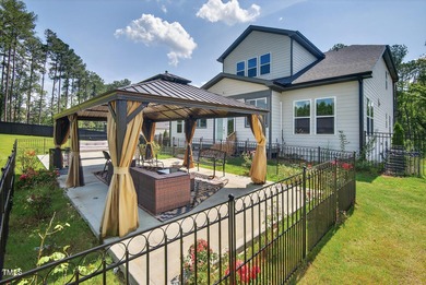 Situated atop a spacious corner lot in Hasentree, this on Hasentree Club in North Carolina - for sale on GolfHomes.com, golf home, golf lot