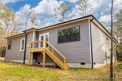 This single-family home offers three bedrooms, two bathrooms on Carolina Trace Country Club in North Carolina - for sale on GolfHomes.com, golf home, golf lot