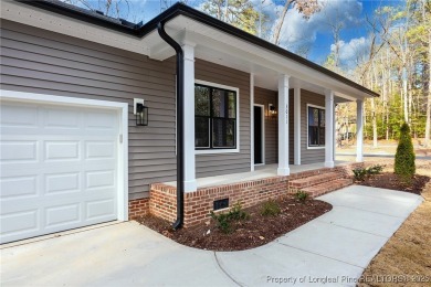 This single-family home offers three bedrooms, two bathrooms on Carolina Trace Country Club in North Carolina - for sale on GolfHomes.com, golf home, golf lot