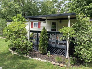 This beautifully maintained and recently updated home has 400 ft on Elk Rapids Golf Club in Michigan - for sale on GolfHomes.com, golf home, golf lot