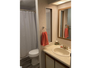 This beautifully maintained and recently updated home has 400 ft on Elk Rapids Golf Club in Michigan - for sale on GolfHomes.com, golf home, golf lot