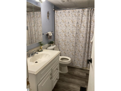 This beautifully maintained and recently updated home has 400 ft on Elk Rapids Golf Club in Michigan - for sale on GolfHomes.com, golf home, golf lot