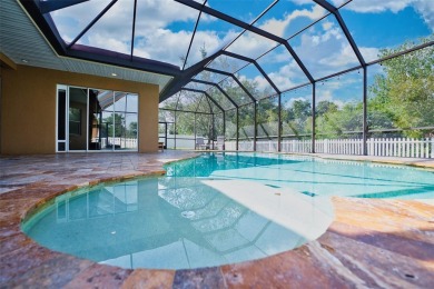 Stunning 4-Bedroom Pool Home with Office  Bonus Room in Gated on Heritage Isles Golf and Country Club in Florida - for sale on GolfHomes.com, golf home, golf lot