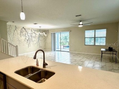 This spacious 8-bedroom, 5-bathroom home in a gated community on The Oasis Club at Champions Gate in Florida - for sale on GolfHomes.com, golf home, golf lot