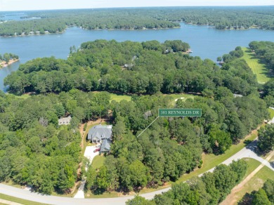 Set along the tranquil 12th green of the prestigious Jack on Great Waters Course At Reynolds Plantation in Georgia - for sale on GolfHomes.com, golf home, golf lot