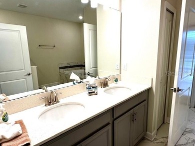 This spacious 8-bedroom, 5-bathroom home in a gated community on The Oasis Club at Champions Gate in Florida - for sale on GolfHomes.com, golf home, golf lot