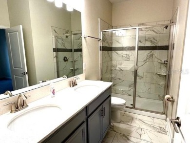 This spacious 8-bedroom, 5-bathroom home in a gated community on The Oasis Club at Champions Gate in Florida - for sale on GolfHomes.com, golf home, golf lot