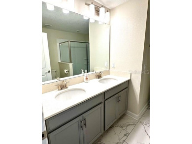 This spacious 8-bedroom, 5-bathroom home in a gated community on The Oasis Club at Champions Gate in Florida - for sale on GolfHomes.com, golf home, golf lot