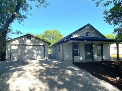 This beautiful new home is tucked into a wooded lot within the on Linn Valley Lakes - Deer Trace Golf Course in Kansas - for sale on GolfHomes.com, golf home, golf lot