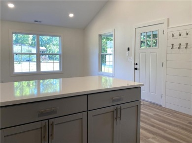 This beautiful new home is tucked into a wooded lot within the on Linn Valley Lakes - Deer Trace Golf Course in Kansas - for sale on GolfHomes.com, golf home, golf lot