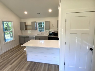 This beautiful new home is tucked into a wooded lot within the on Linn Valley Lakes - Deer Trace Golf Course in Kansas - for sale on GolfHomes.com, golf home, golf lot