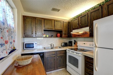 Charming first-floor condo with golf and green space views plus on The American Golf Club in Florida - for sale on GolfHomes.com, golf home, golf lot