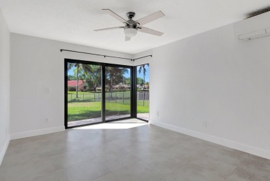 Nestled in the heart of Boca Woods Country Club, this home sits on Boca Woods Country Club in Florida - for sale on GolfHomes.com, golf home, golf lot