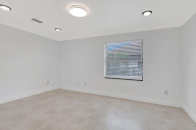 Nestled in the heart of Boca Woods Country Club, this home sits on Boca Woods Country Club in Florida - for sale on GolfHomes.com, golf home, golf lot