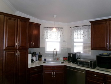 This lakefront beauty is loving maintained and super clean. With on Tomoka Oaks Golf and Country Club in Florida - for sale on GolfHomes.com, golf home, golf lot