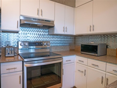 Welcome to Crystal Bay, where a bright and updated condo waits on Feather Sound Country Club in Florida - for sale on GolfHomes.com, golf home, golf lot