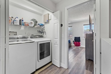 Affordable and stylishly renovated waterfront townhouse in the on Woodmont Country Club in Florida - for sale on GolfHomes.com, golf home, golf lot